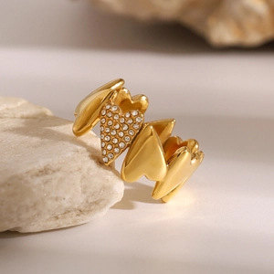 Detailed close-up of 18k gold-plated irregular heart rings with sparkling zircon accents