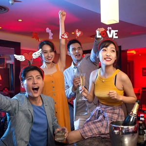 Group of friends wearing heart and wing headbands at a vibrant bachelorette party event