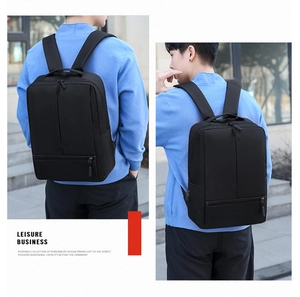 Detail view of the USB charging port and sleek side profile of this black business backpack