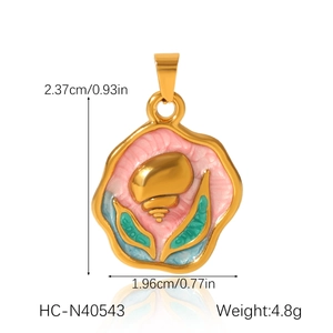 Detailed size view of gold enamel seashell pendant with pink background and blue leaves