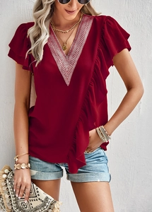 Close-up of wine red short sleeve top featuring V-neck lace and ruffle details