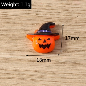 Macro detail of pumpkin witch head resin charm for DIY Halloween craft projects
