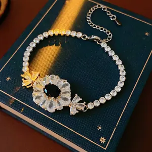 Elegant zircon flower bracelet with black oval stone on vintage book backdrop