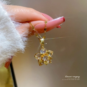 Titanium steel snowflake zircon pendant necklace shown on a model neck in gold finish
