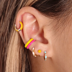 Close-up of colorful enamel bamboo hoop earrings and micro-inlaid zircon studs on ear