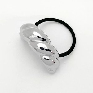 Detail of twisted silver metal U-shape charm on a black high-elastic hair tie