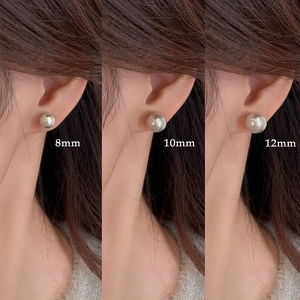Comparison of 8mm, 10mm, and 12mm grey pearl stud earrings on model for size perspective