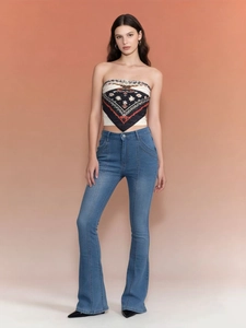 Full view of retro low-waist flare jeans with vintage ethnic print tube top on a model