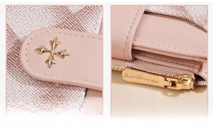 Detailed shot of pink leather wallet featuring gold cross buckle and metal zipper hardware