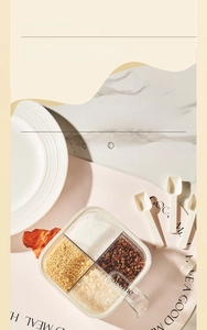 Detail view of 4-compartment seasoning box with spoons on marble kitchen countertop