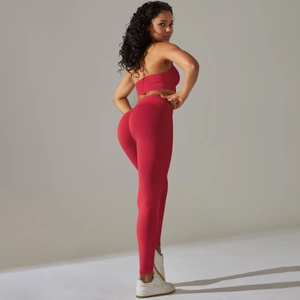 Detail of red seamless ribbed workout set with sports bra and high-waisted leggings