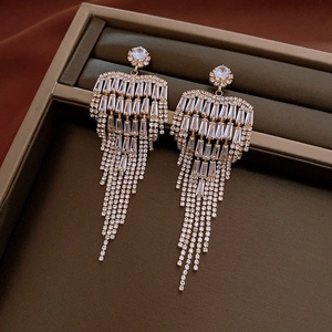 Macro shot of silver bow tassel earrings featuring sparkling crystal rhinestones details