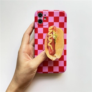 Macro view of a 3D hot dog phone grip on a red and pink checkerboard phone case