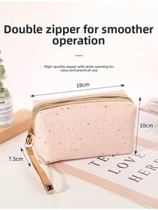 Pink cosmetic bag with gold stars and dual zippers shown with 18x10x7.5cm dimensions