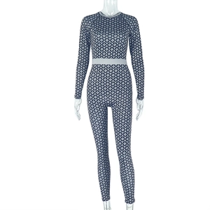 Detail of navy blue geometric print bodysuit with elastic waistband and slim fit stretch fabric