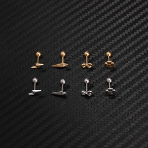 Macro shot of gold and silver lightning bolt and geometric stud earrings set