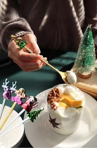 Detailed view of UV plated Christmas dessert spoons with colorful holiday character charms