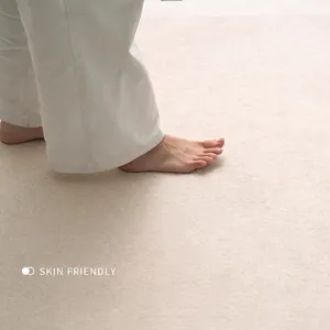 Soft beige chenille rug with thick skin-friendly texture shown with bare feet for comfort
