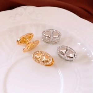 Detailed close-up of 18K gold plated oval earrings with micro-inlaid zircon crystals