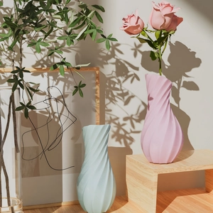 Detailed view of spiral textured silicone vases with matte finish and soft floral accents