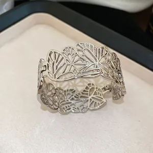 Minimalist silver open cuff bracelet featuring hollow butterfly design and hinge structure
