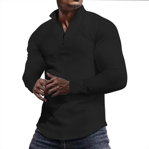 Detailed view of black waffle knit texture on men's stand collar quarter-zip sweatshirt