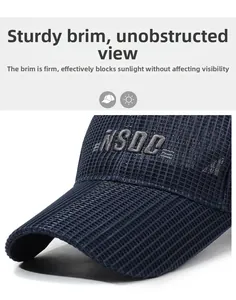 Detailed view of navy mesh baseball cap with gray NSDC embroidery and curved sun visor