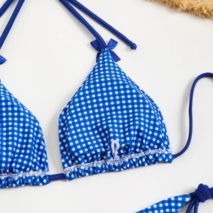 Detail of blue and white checkered bikini top with scalloped edges and cute bows