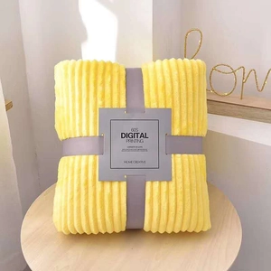 Detailed texture of yellow flannel throw blanket with ribbed pattern and gift wrap