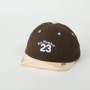 Detail of baby soft brim cap showing Est. 23 embroidery and cotton twill texture