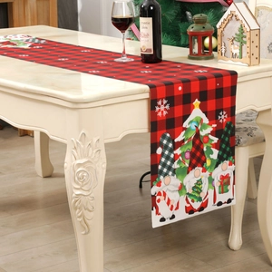 Christmas table runner with buffalo plaid, festive gnomes, and snowflakes on a dining table