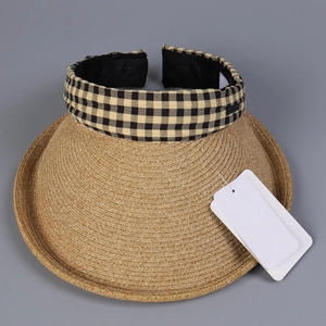 Detailed view of sun visor hat with straw brim and yellow plaid fabric headband