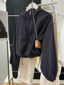 Minimalist black windbreaker hoodie with zipper and drawstring hem for casual wear