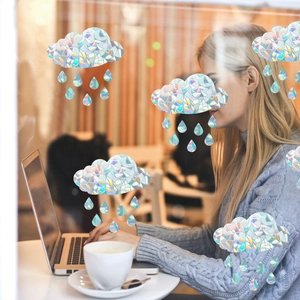 Rainbow prism cloud and raindrop window stickers creating colorful holographic light on glass