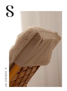Close-up of thick faux rabbit fur cushion with soft texture on a wooden chair