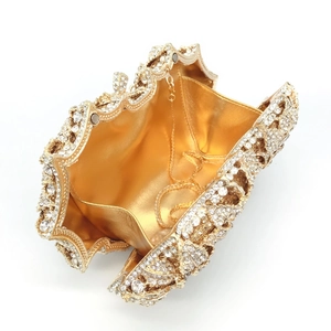 Detailed top view of open luxury rose-shaped gold evening bag with rhinestone lining