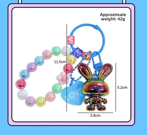 Close-up of acrylic rabbit keychain with rainbow metal finish and colorful beads