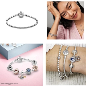 Detailed macro view of S925 silver snake chain bracelet with blue enamel heart charms
