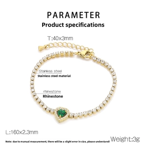 Detail view of golden stainless steel tennis bracelet with green heart and white crystals
