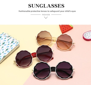 Close-up of round floral children sunglasses in brown red and black stylish frames