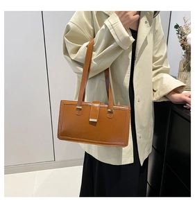 Brown retro leather shoulder bag shown on model for size perspective and daily style