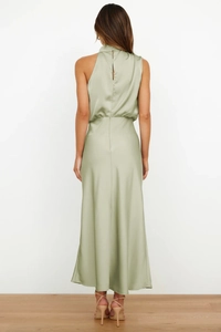 Rear view of elegant sage green satin halter dress with smooth glossy finish