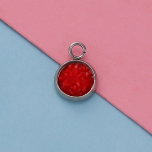 Detail shot of a 12mm stainless steel round pendant with red textured resin inlay