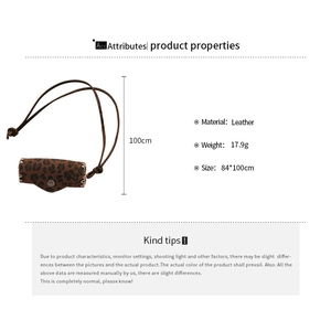 Detail of leopard print leather mini bag pendant showing white stitching and metal snap