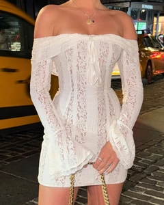 Detail of white lace off-shoulder mini dress featuring elegant flared sleeves and corset tie