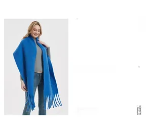 Detail shot of bright blue mohair scarf fabric texture and long fringe tassels