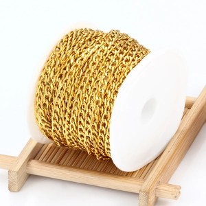 Golden stainless steel Cuban link chain roll on white spool for DIY jewelry making