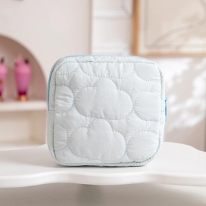 Close-up of light blue cloud-quilted fabric storage bag with color-matched zipper