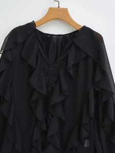 Detailed view of ruffle layers on a black chiffon long sleeve V-neck blouse