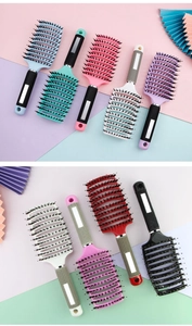 Detailed view of curved vented hair brushes in various colors with non-slip handles